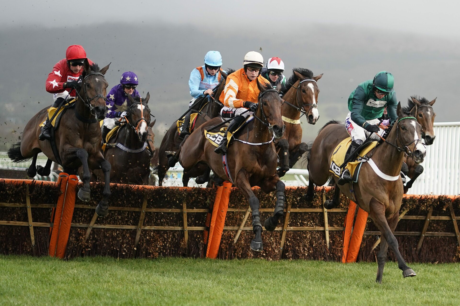 Image of horses jumping over hurdle in the may racing weekend at Ascot