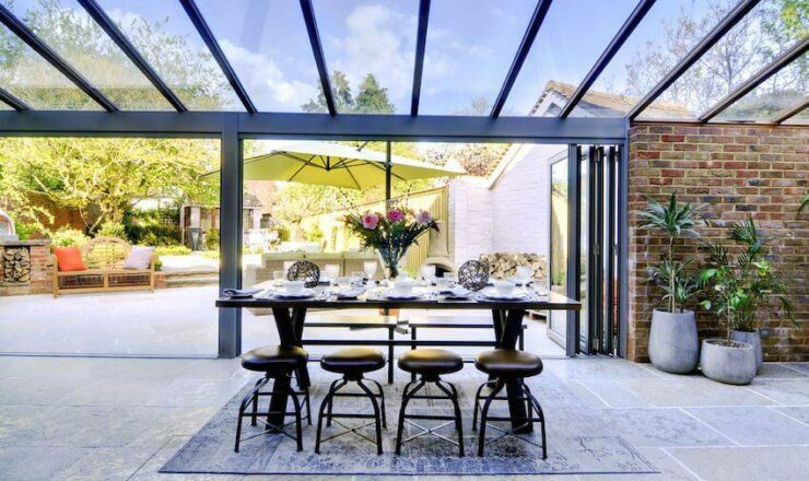 Image of Dining area in Lavendar House underneath a sky roof looking onto outdoor area