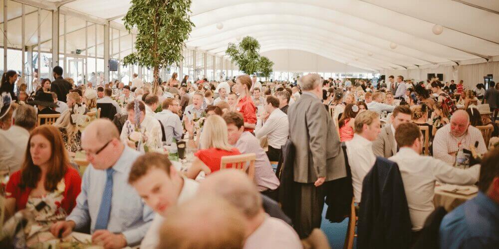 Image of people in the marquee hospitality suite with a buzzing atmosphere