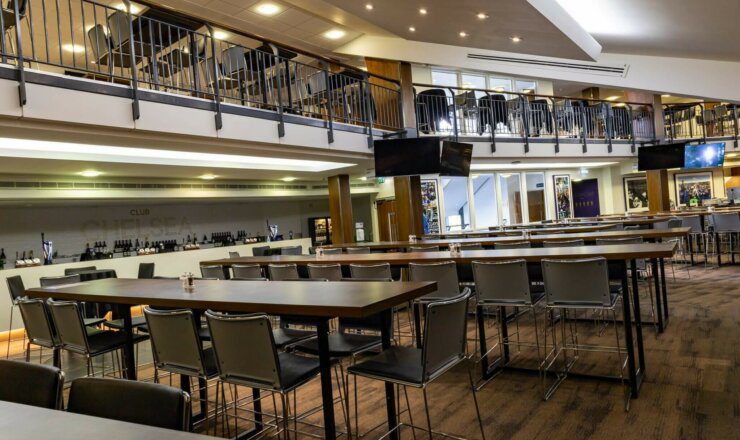Large suite/bar prepared with tables with guests to sit at before or during the football match